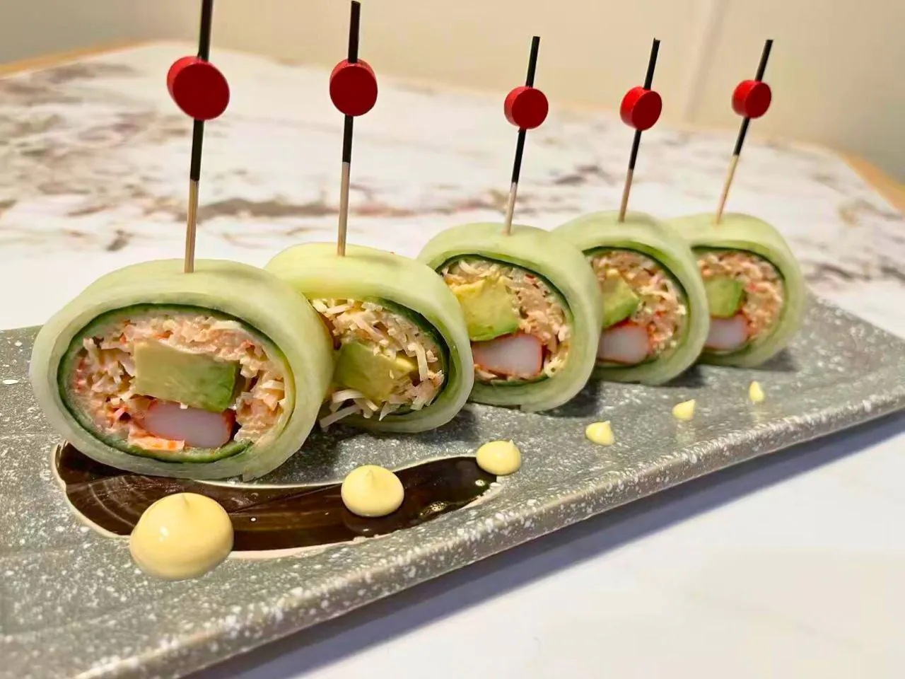 Sushi rolls wrapped in cucumber with shrimp, avocado and crab at Umami Ramen & Sushi House, a Japanese Restaurant in Wilmington